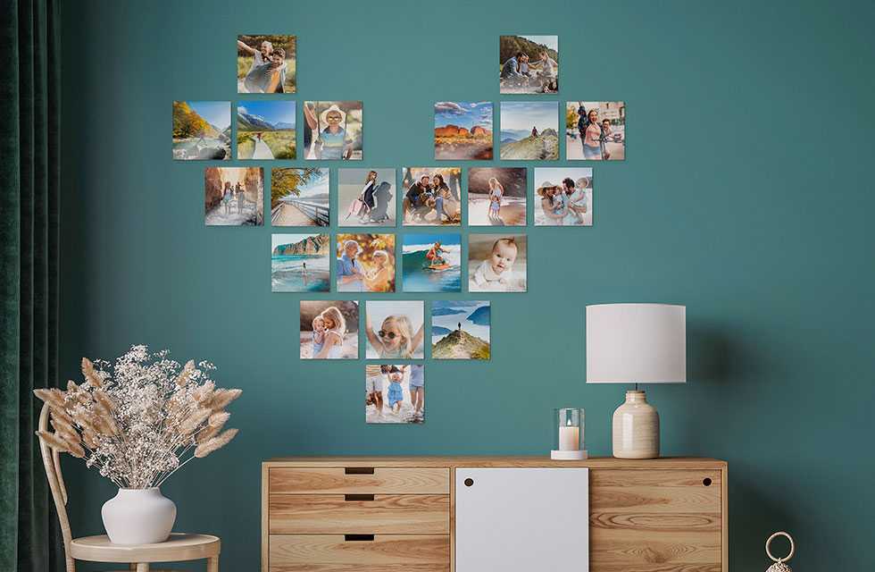 Multiple Snapfish Photo Tiles are displayed in the shape of a heart on a green wall above a dresser with a lamp on top
