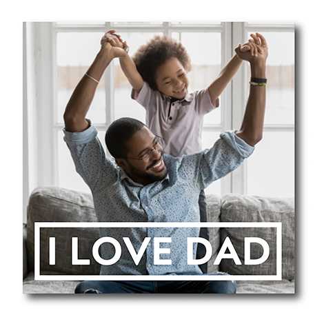 Snapfish Photo Tile featuring an image of a child standing on a sofa behind his father with the phrase I love dad at the bottom