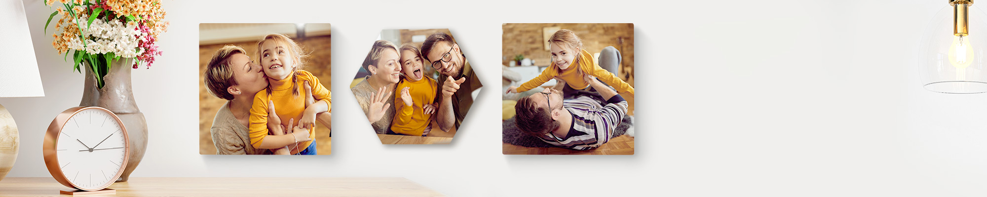 Snapfish Photo Tiles featuring child portraits, family photos, and vacation photos displayed on wall above a sofa