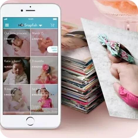 phone with baby picture on screen and stack of images 